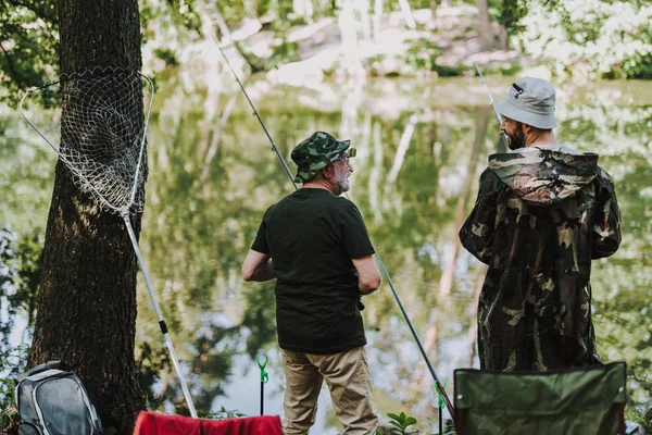 Rear view of positive anglers enjoying fishing — Stock Photo, Image