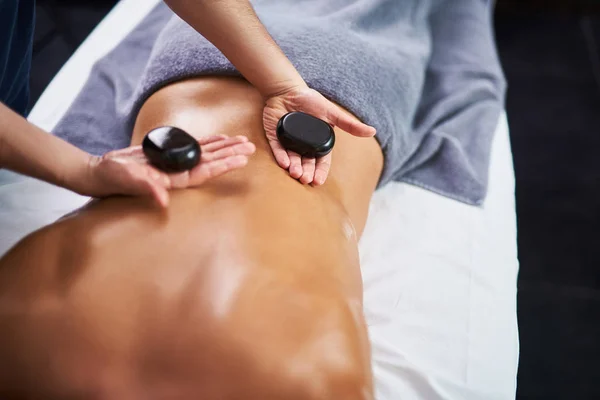 Jeune homme allongé sur une table de massage pendant la procédure spa — Photo