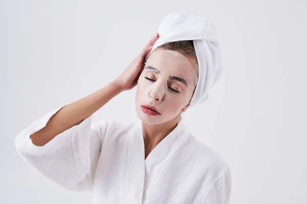 Young lady with closed eyes having purifying mask on her face — Stock Photo, Image