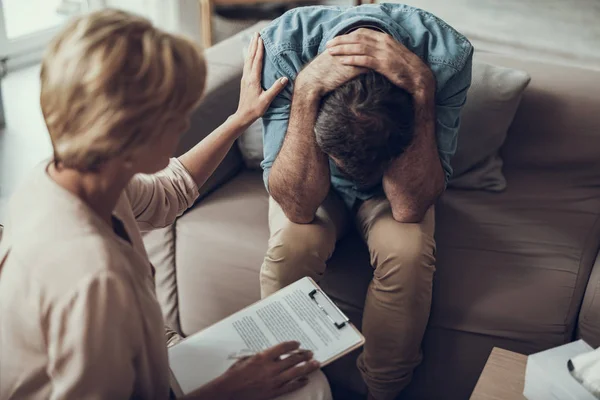 Female psychotherapist is comforting her depressed patient — Stock Photo, Image