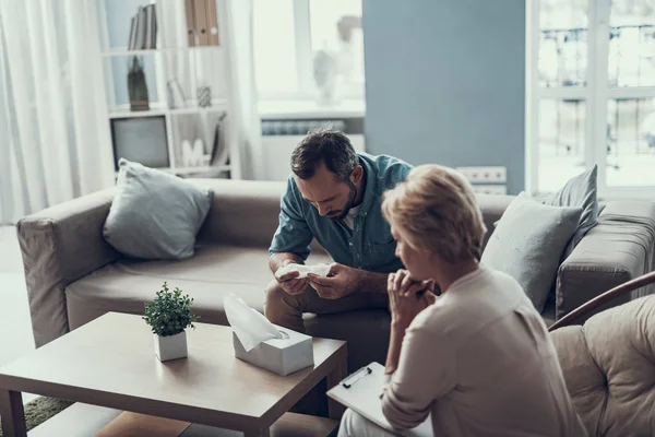 Kalm psychotherapeut zit naast haar doordachte cliënt — Stockfoto