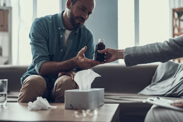 Rustige man glimlachend en innemen van de medicijnen van de specialist — Stockfoto