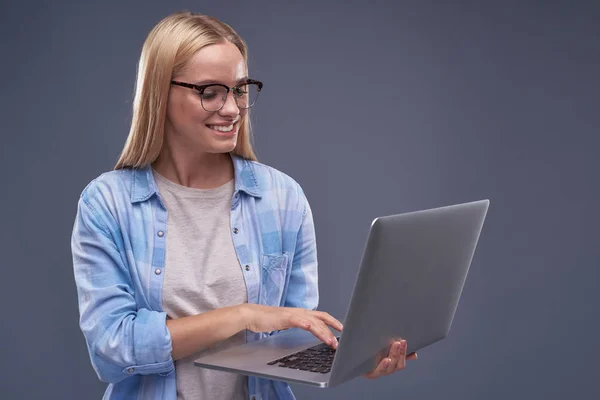 Красива молода леді в окулярах, використовуючи сучасний ноутбук — стокове фото