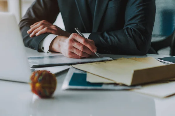 Gros plan de l'homme en costume prenant des notes à la table — Photo