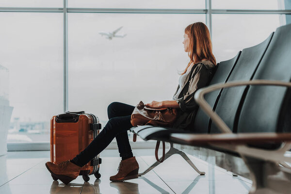 Calm lady is spending time at airport