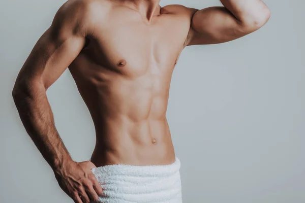 Slim muscular man posing with towel on hips — Stock Photo, Image