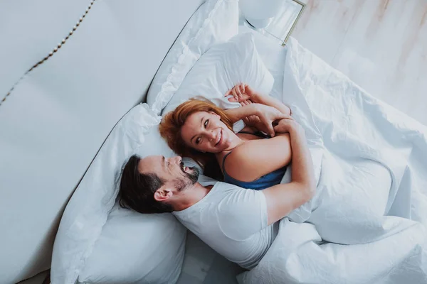 Adult happy couple spending time in bedroom — Stock Photo, Image