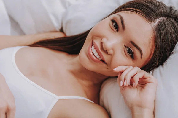 Smiling asian girl awaking after good dream at home — Stock Photo, Image