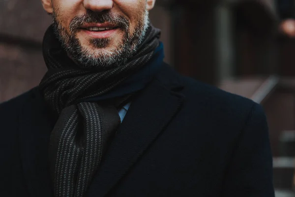 Carefree trendy man in black coat is outside — Stock Photo, Image