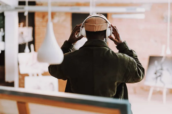 Rare view of man wearing headphones while being in art gallery — Stock Photo, Image