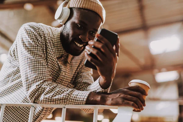 Close up of positive Afro-American man using his smartphone — Stock Photo, Image