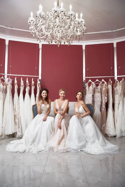 Três noivas felizes sentadas em vestido de noiva — Fotografia de Stock