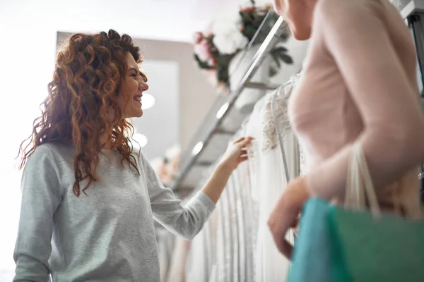 Señora alegre elegir vestido de novia en la tienda de bodas — Foto de Stock