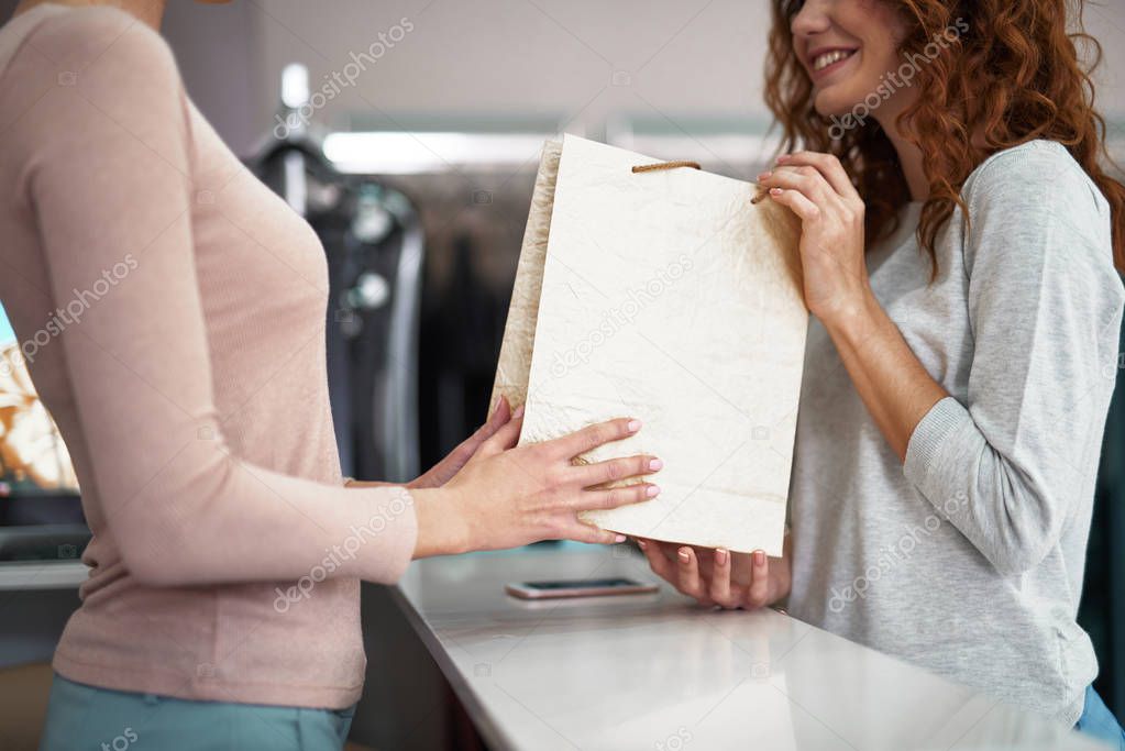 Close up of young lady holding purchase packet