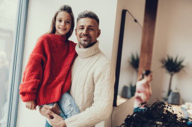 Küçük kız babası ellerde oturan