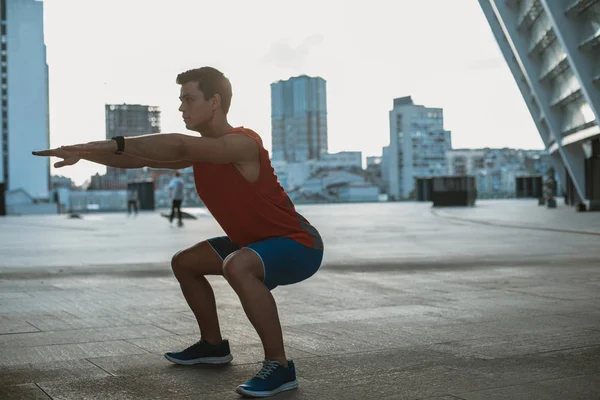 Επικεντρωμένη αρσενικό αθλητής κάνοντας σωματική άσκηση εξωτερική — Φωτογραφία Αρχείου