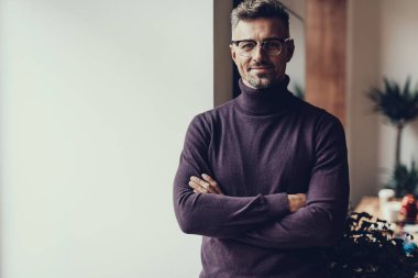 Kameraya bakarak ve gülümseyen olgun adam