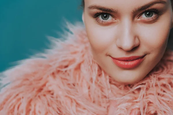 Confident smiling young lady in peach fur coat — Stock Photo, Image