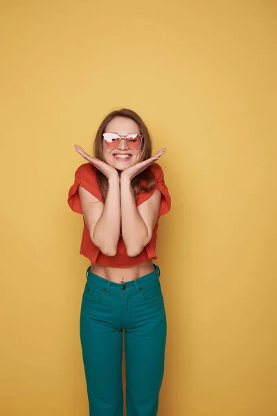 Taille van lachende brunette jonge dame in brillen poseren voor de camera — Stockfoto