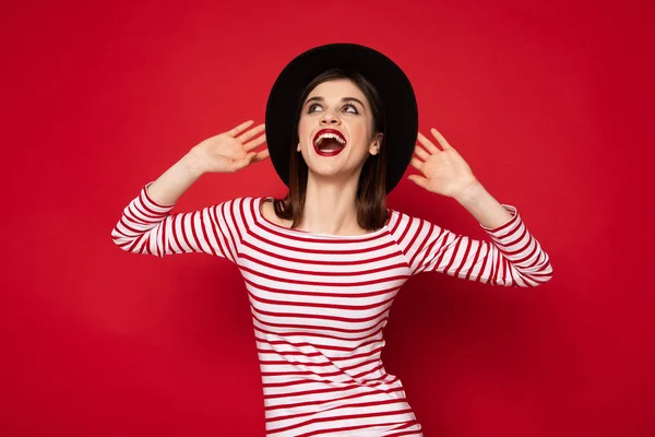 Excited happy lady in striped blouse and boater