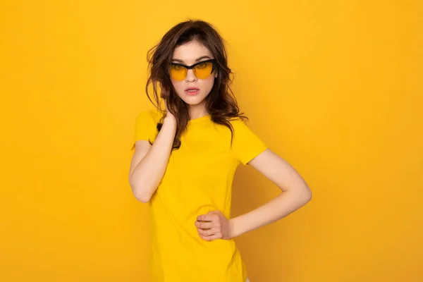 Fashion looking stylish girl isolated on yellow