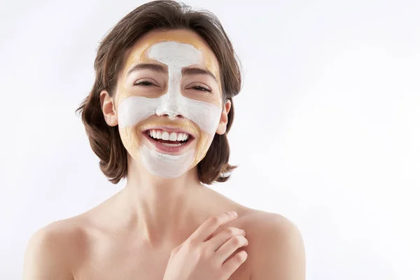 Happy laughing pretty woman with face mask — Stok Foto