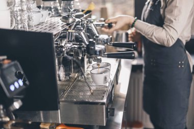 Barista yanında dururken fincanlara kahve dökülürken