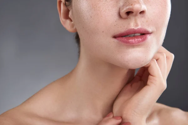 Young woman with beautiful rosy lips touching her neck — Stock Photo, Image