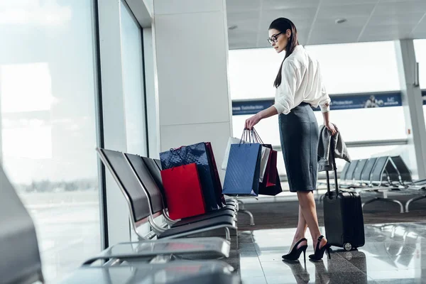 Mujer joven con equipaje está esperando avión — Foto de Stock