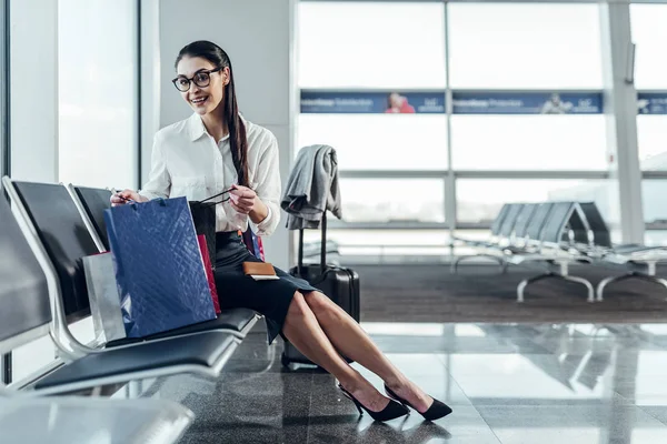 Femme heureuse se prépare pour voyager par avion — Photo