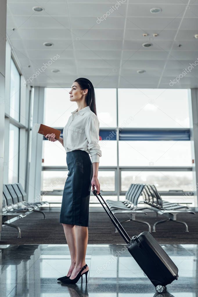 Happy elegant woman is ready for boarding