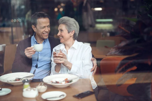 Smiling elegant aged couple happy to meet in cafe — Stock Photo, Image
