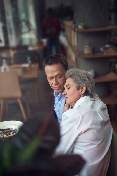 Relaxed aged couple enjoying dinner in cafe — Stock Photo, Image