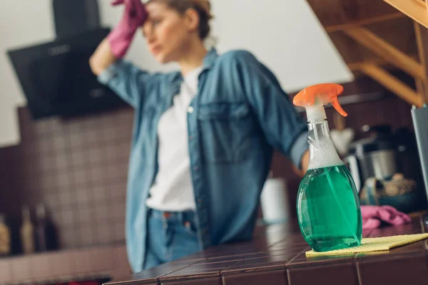 Mujer cansada de limpiar la superficie de la cocina en casa — Foto de Stock