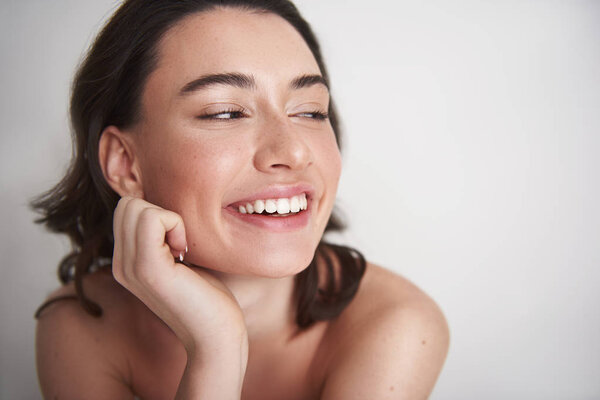 Portrait of cheerful smiling female on white