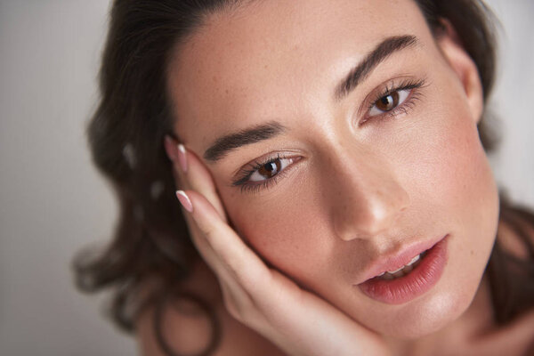 Close up portrait sensual brunette female on white