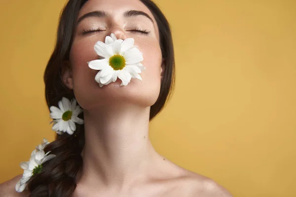 Close-up sierlijke brunette vrouw met camomiles — Stockfoto