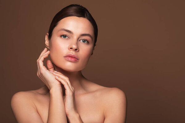 Pretty woman with bare shoulders looking at the camera