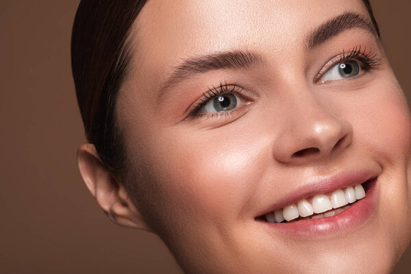 Face of the woman looking away and smiling happily