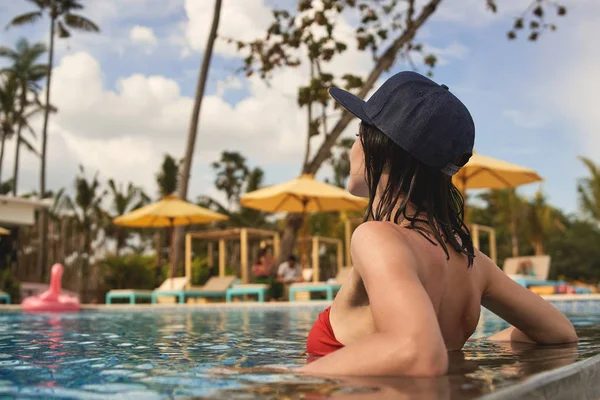 Young lady is relaxing in water while resting in hotel — Stock Photo, Image