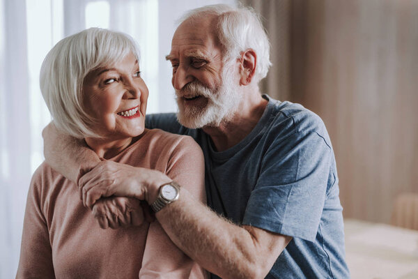 Close up happy elder man embracing his wife