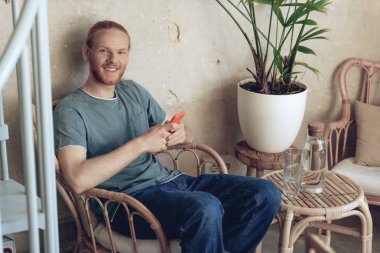 Merry adam telefon ile kafede zaman geçiriyor