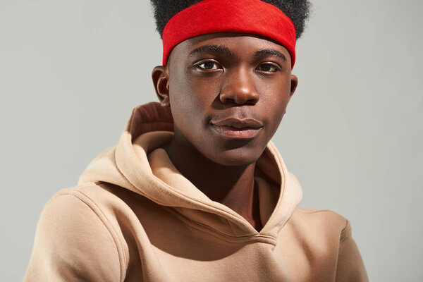 Serene young guy posing and looking at camera