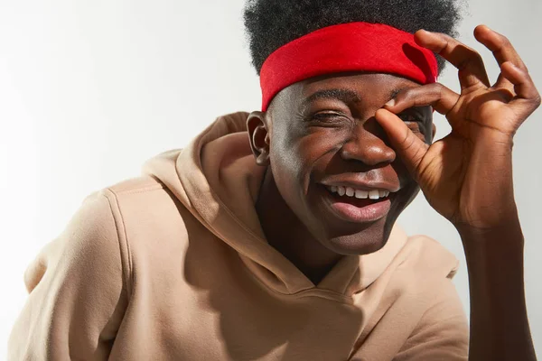 Cheerful young guy is having fun on white background