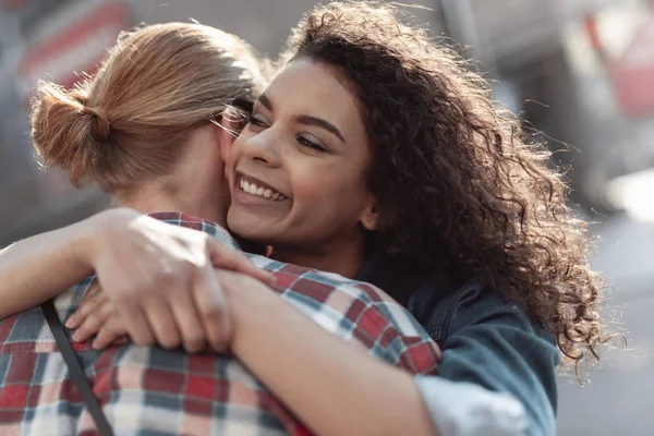 Jovencita alegre está abrazando chico fuera — Foto de Stock