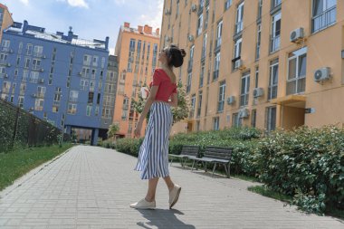 Sokakta yürüyen take-away içki ile güzel genç kadın