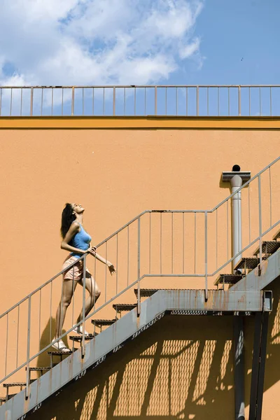 迷人的年轻女子走在街上的楼梯 — 图库照片