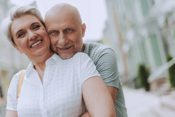 Smiling gray-haired couple is having rest together — Stock Photo, Image