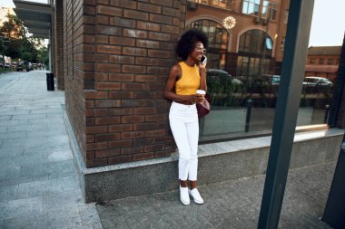 Mutlu afro-amerikan kadın akıllı telefonda konuşuyor