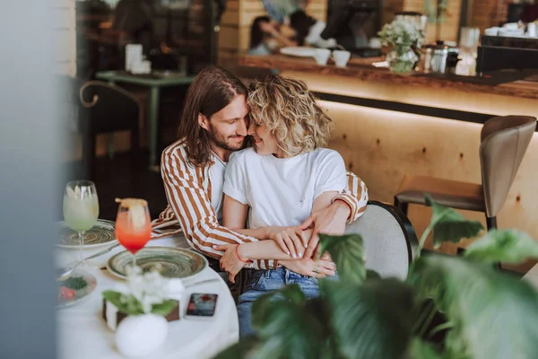 Bella coppia innamorata che si abbraccia e tocca il naso nel caffè — Foto Stock